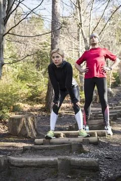 Couple relaxing while training on obstacle course in nature Stock Photos
