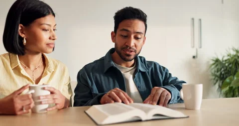 Couple, rest and reading in home with bible, study scripture and morning prayer Stock-Footage 337040610