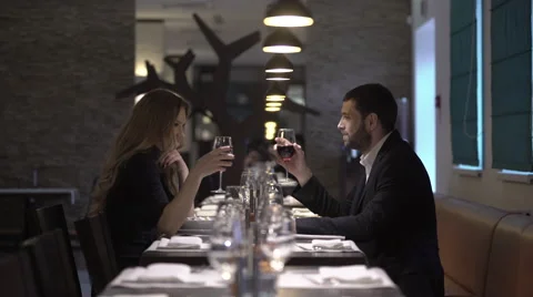 Couple in a restaurant is drinking wine Stock Footage 61368346