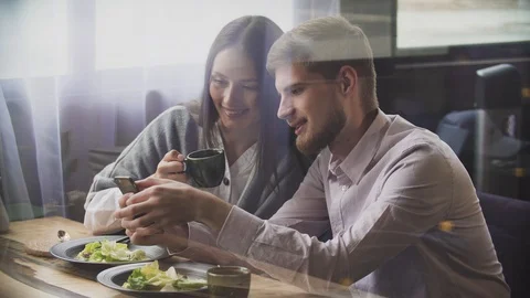 Couple at restaurant looking at his smart phone Stock-Footage 111246745