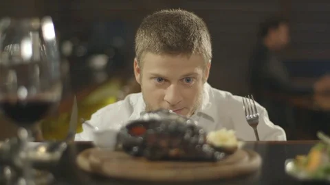 Couple in restaurant - man hunting his steak Stock Footage