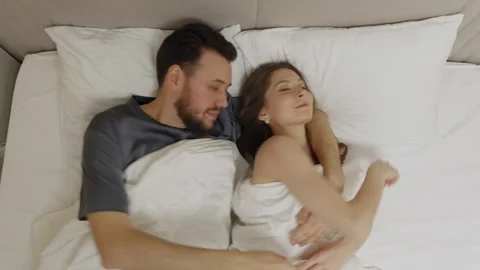 Couple resting on bed seen from above, calm intimacy Stock Footage 329242839