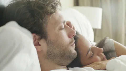 Couple resting in bed together Stock Footage 75176667