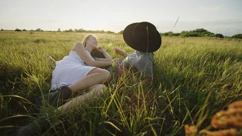 Couple resting on grass in field Video stock 219951661