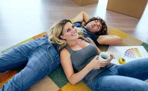 Couple resting lying on the carpet Stock Photos