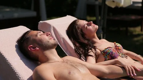 Couple resting near the pool Stock Footage 75392811