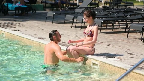 Couple resting in the pool Stock Footage 75392769