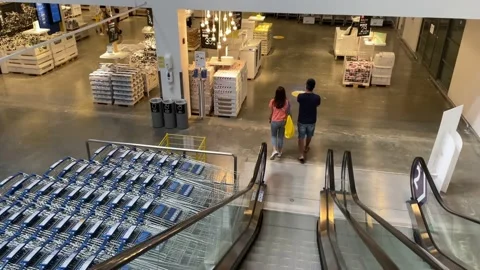 Couple ride down escalator at IKEA Store Bang Yai inside Central Plaza Westgate Stock Footage 171594659