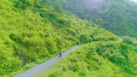 Couple Riding Bike In Mountains Stockbeeldmateriaal 234179853