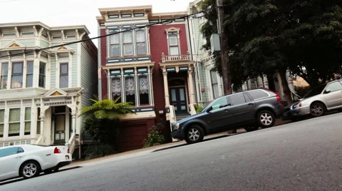 Couple riding bikes down the San Francisco street Stock Footage 64013019