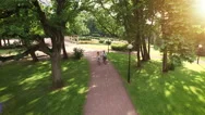 Couple Riding Bikes In Park. Aerial Shot. Stock Footage