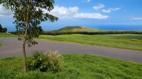 Couple Riding Bikes Past Fields at a Ranch in Hawaii Stock Footage 92886103