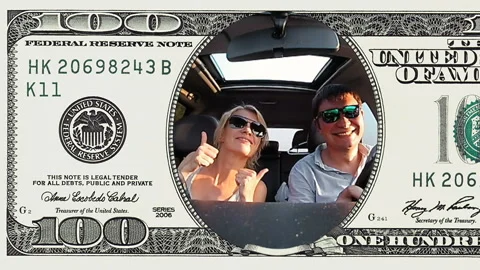 Couple is riding a car in frame of 100 dollar bill Stock Footage 96999341