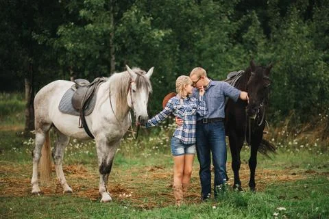 Couple riding in forest Stock Photos
