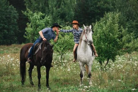 Couple riding in forest Stock Photos