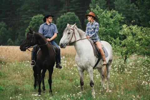 Couple riding in forest Stock Photos