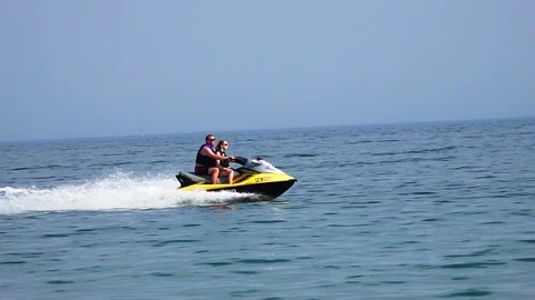 Couple riding on a jetski Stock Footage 91281478