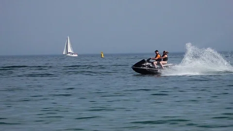Couple riding on a jetski Stock Footage 91304808
