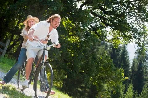 Couple riding old bicycle Stock Photos