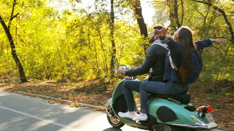 Couple riding a scooter. Stock Footage 97768380