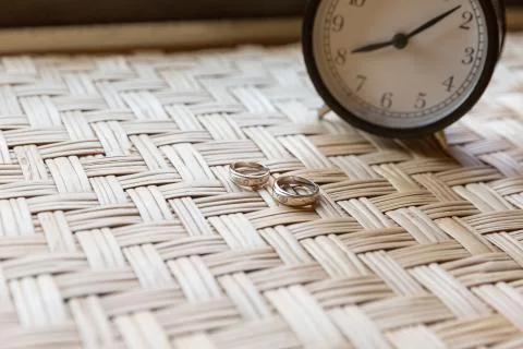 Couple ring on weave table with clock Stock Photos