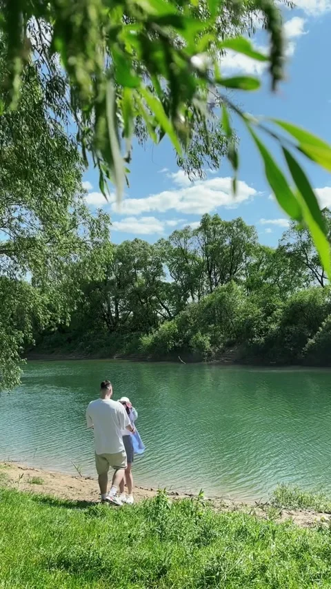 Couple at the river beach Stock Footage 247072207