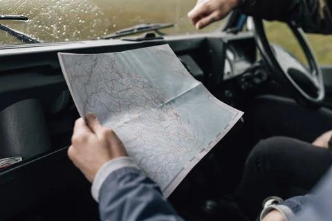 Couple on a road trip checking the map Stock Photos