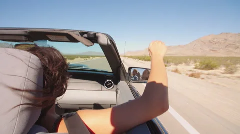 Couple On Road Trip Driving In Convertible Car Shot On R3D Stock Footage