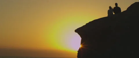 Couple on a rock at sunset, anamorphic Stock Footage 46035824