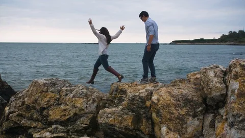 Couple on Rocks on Coastline Beach, Cloudy Rock Coast Stock Footage 102445402