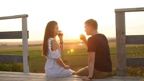 Couple on romantic date at beach restaurant at sunset Stock Footage
