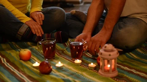 Couple on a romantic date, sitting on the floor, among a candles Stock-Footage 68610910