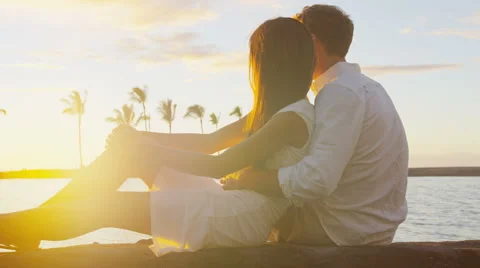 Couple romantic sunset happy in love embracing enjoying travel vacation at beach Stock Footage