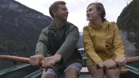 Couple  is rowing on the boat in the middle of the mountain lake Stock Footage 83625086