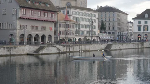 Couple rowing on the Limmat River flowing through the centre of Zurich Stock Footage 122952005