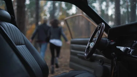 Couple run from the car in forest Stock Footage 91775895