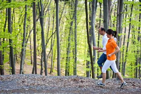 Couple of runners in forest. Stock Photos