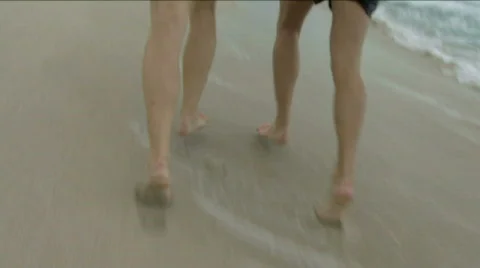 Couple running and playing on a beach Stock Footage