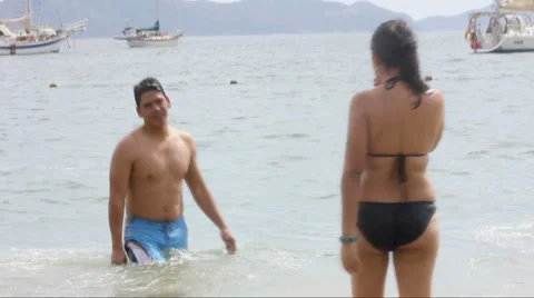 Couple running and playing on the beach Stock Footage 1092925