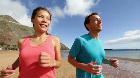 Couple running on beach Stock Footage 37597955