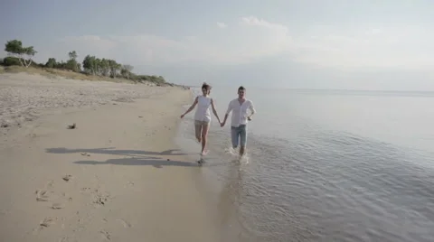 Couple Running on a Beach Stock Footage 61795477