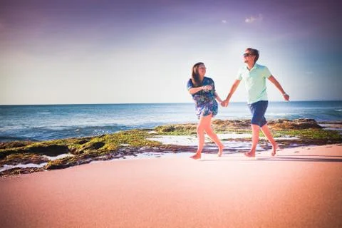 Couple running at the beach Stock Photos