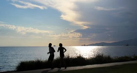 Couple running on the beach Stock Photos