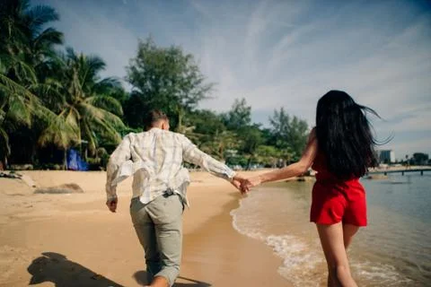 Couple running on a beach Stock Photos