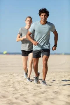 Couple running on the beach Stock Photos
