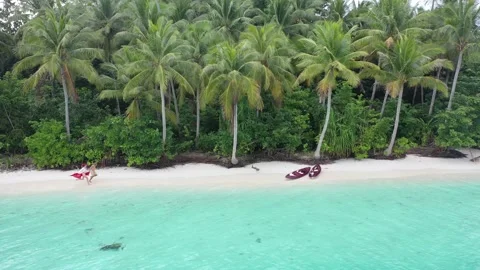 Couple Running Down White Sand Beach in Raja Ampat Adventure Done Shot Stock Footage 197059086
