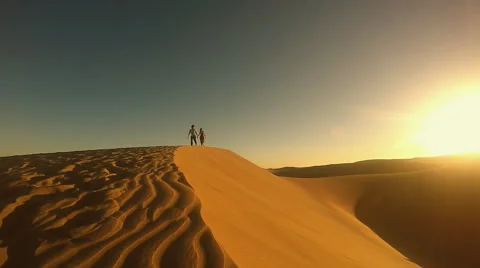 Couple running on dune Stock Footage