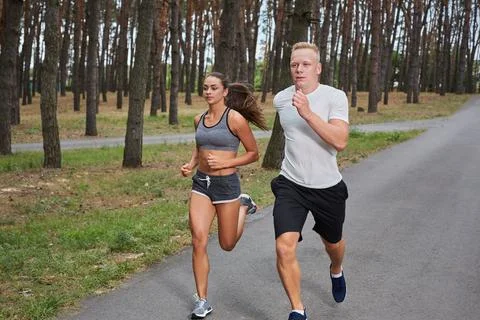 Couple running in forest Stock Photos