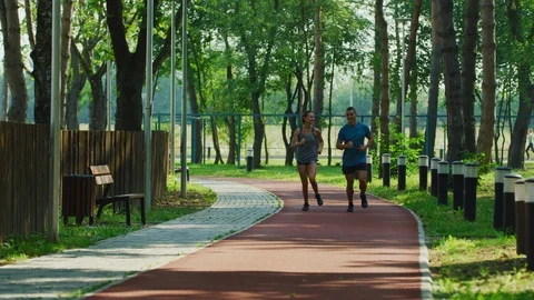 Couple running in a park Stock Footage 100032115