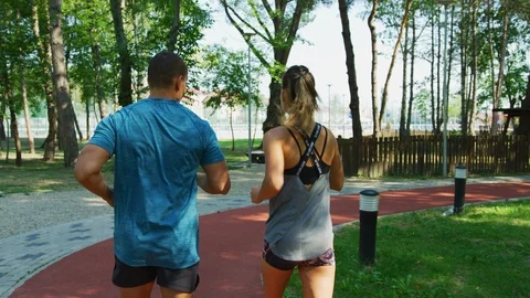 Couple running in a park Stock Footage 100032916